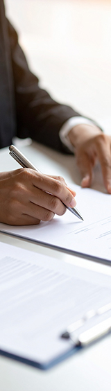 Firefly_Close-up of professional hands reviewing official paperwork or legal documents on a d 137262-160x564